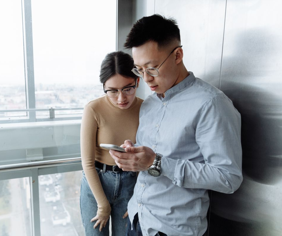 People gathered together looking at a phone screen
